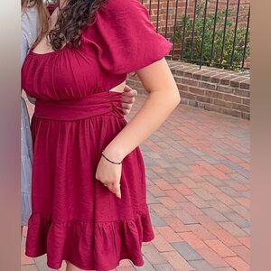 Burgundy red mini dress with puffy shoulders, bow, and back cut out. Women’s L